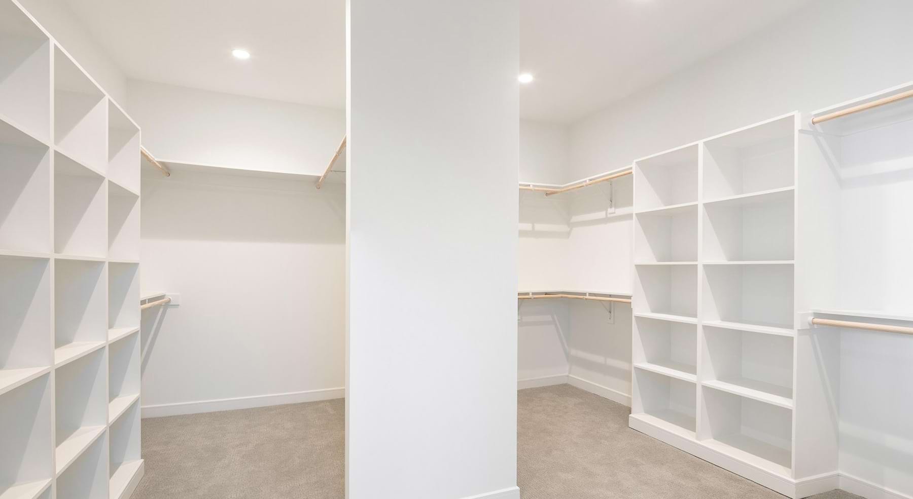 a closet with white walls and shelves