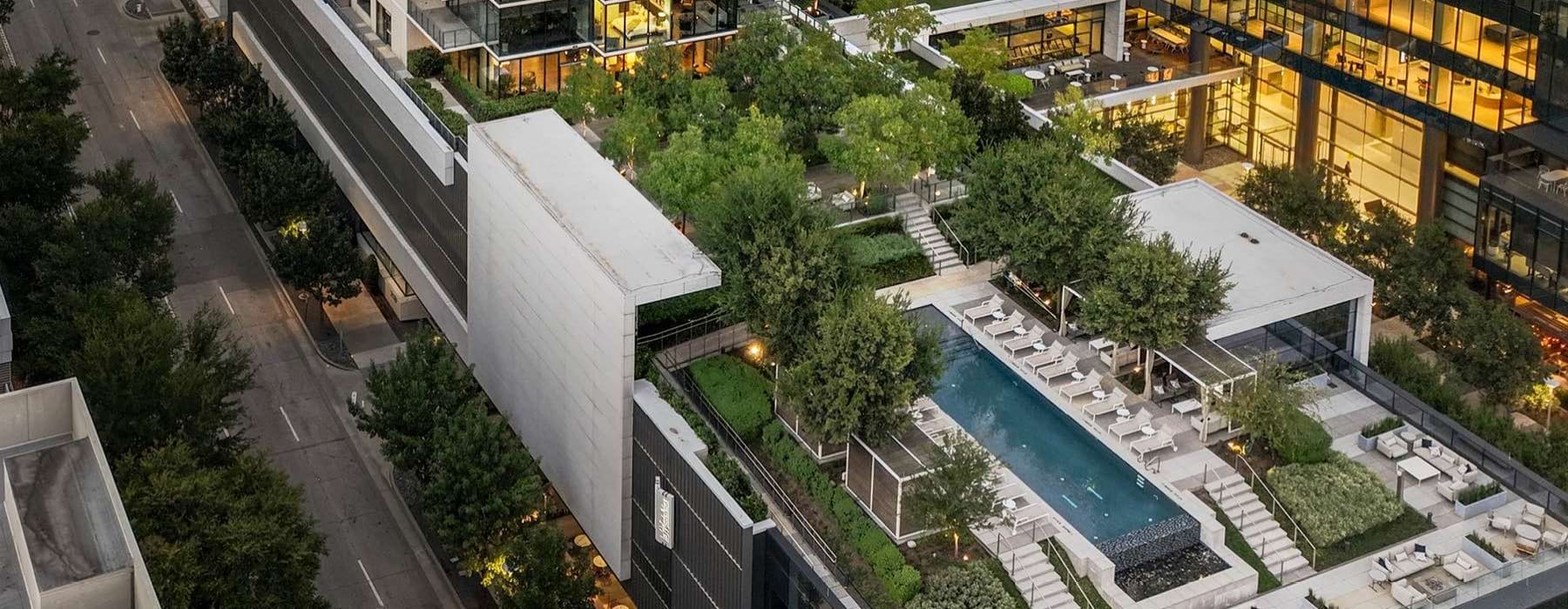 a building with a pool and trees
