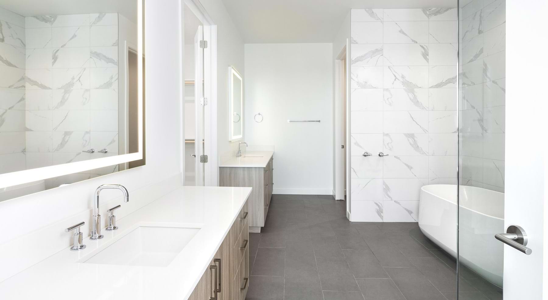 a bathroom with a sink, mirror and a tub