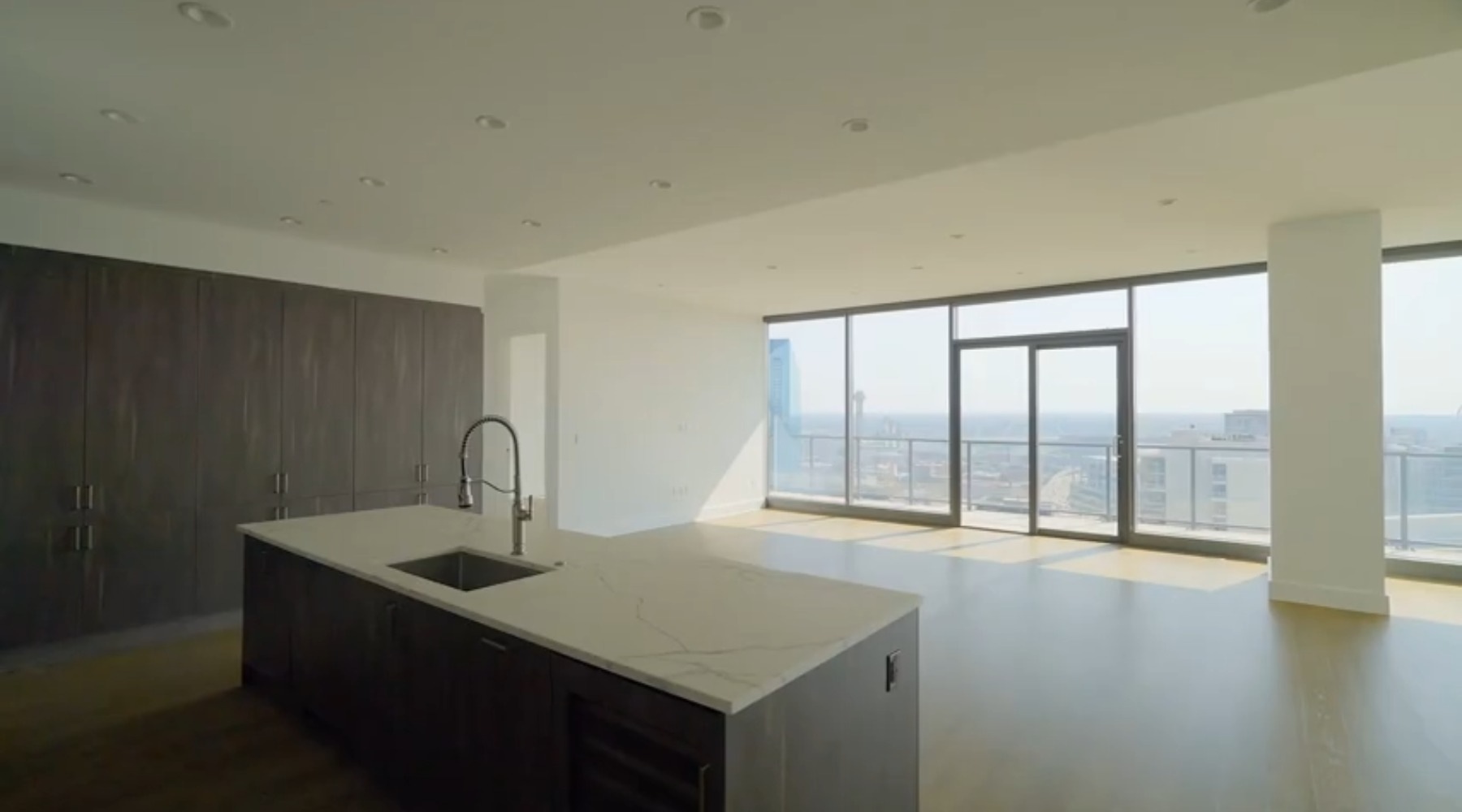 a kitchen with an island and large windows